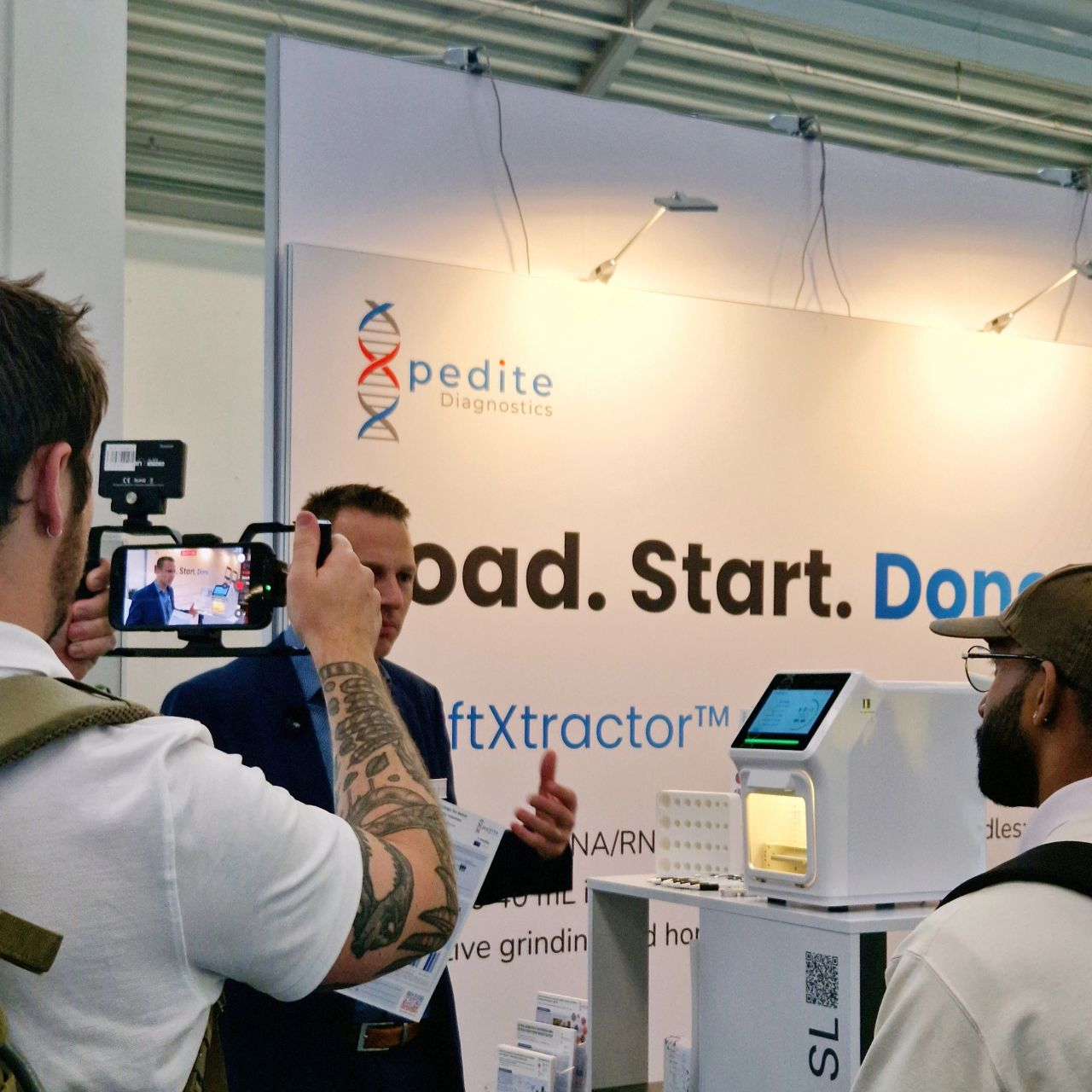 Filming a product demonstration at the booth.