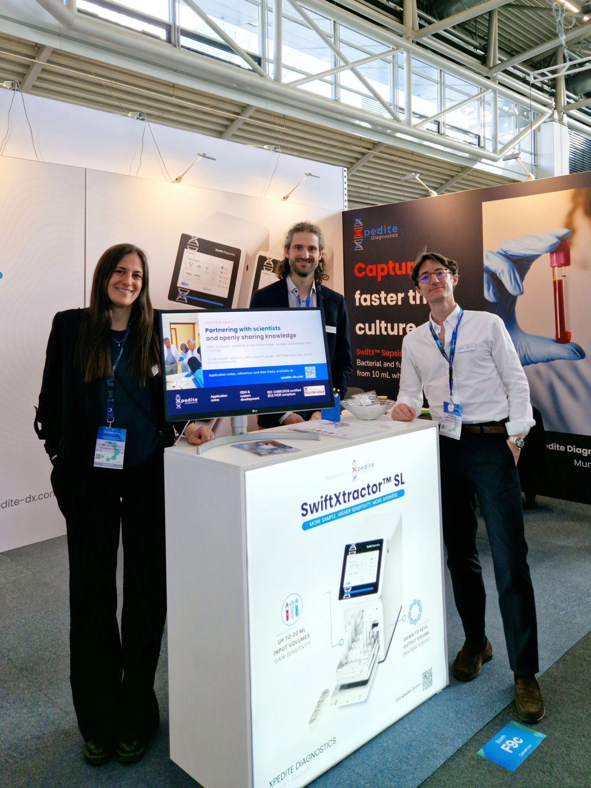The Xpedite team at the SwiftXtractor SL podium in booth F9c.